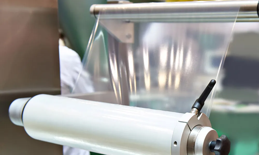 Clear POF shrink film pulled from a roll on a packing machine
